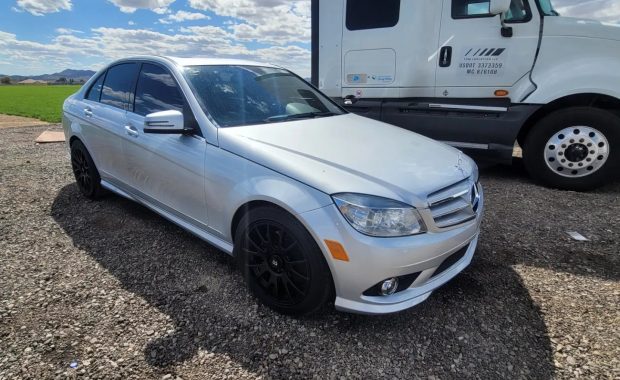 white mercedez benz car and truck